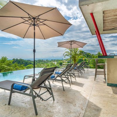 Wonderful pool deck, sun chairs and bar is great for enjoying the pool area.