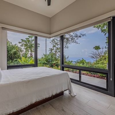 Bedroom #2 has ocean views, views of the swimming pool+waterfall and patio/swimming pool access from the bedroom.