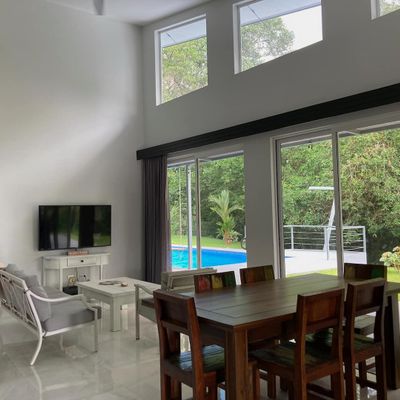 spacious living area, designed with large windows that frame the pool perfectly.