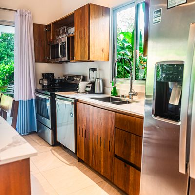 A cozy kitchen that opens up to a beautiful poolside view, blending indoor and outdoor living.