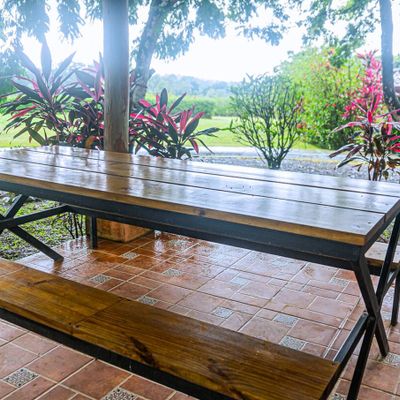 A spacious grill area with a large dining table, perfect for family gatherings.