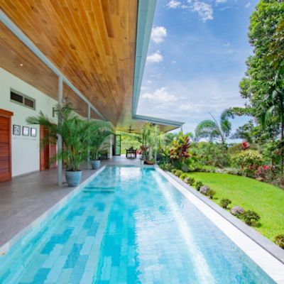 A wide, sparkling pool with plenty of space for swimming and lounging.