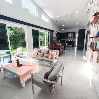 spacious living area, designed with large windows that frame the pool perfectly.