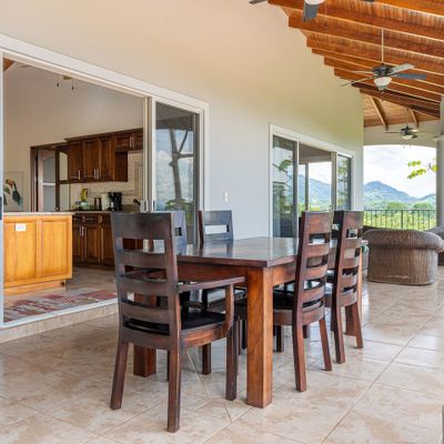 charming seating area with a table and chairs next to the pool.