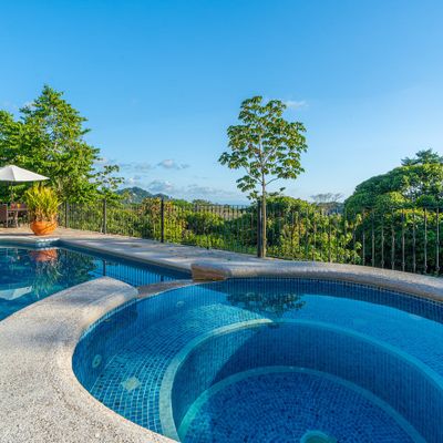 Large swimming pool with smaller plunge pool for sitting and relaxing
