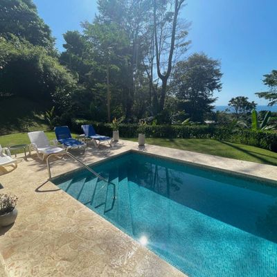 The beautiful sunlight shimmering on the pool, creating a sparkling, serene effect.