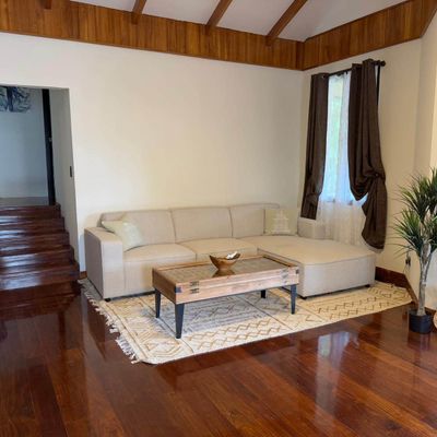 Large TV and living room in Main House on second floor with balcony.