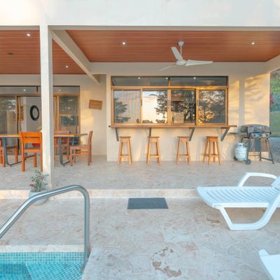 A stylish BBQ area by the pool, perfect for cooking and relaxing with friends or family