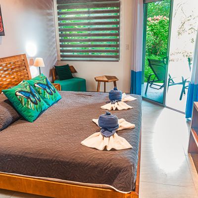The main bedroom offers a relaxing ambiance with direct views of the pool.