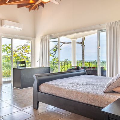 Owner's Suite with en-room bathroom, desk, access to patio.
