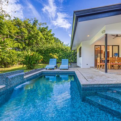 spacious pool area surrounded by lush landscaping.
