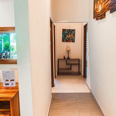 A well-lit hallway that seamlessly connects all three bedrooms