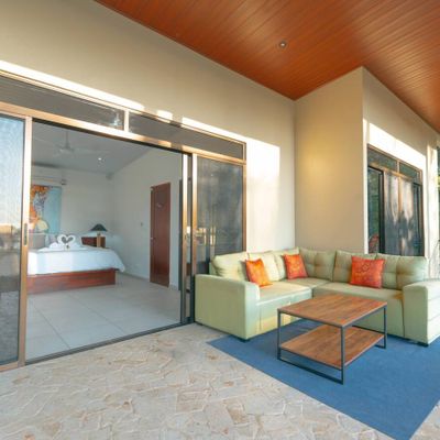 A chic outdoor lounge area, blending modern comfort with nature’s tranquility.