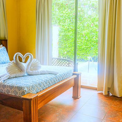 The master bedroom features a private bath, abundant daylight, and a scenic view of the pool.