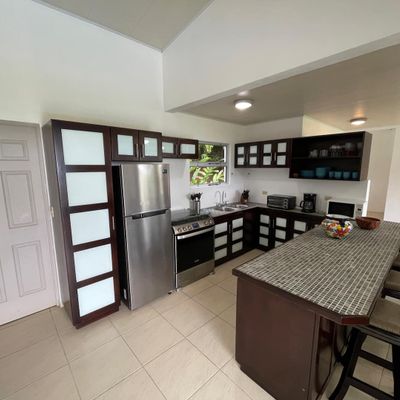 Well-equipped and designed kitchen allows easy flow and socializing while preparing food/drinks.