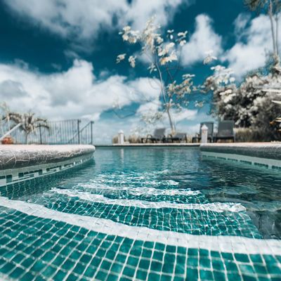 A luxurious pool with sparkling, crystal-clear water, perfect for enjoying the outdoors.