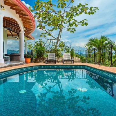 A spacious poolside lounge area, perfect for relaxing and enjoying the sun.