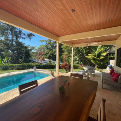 beautiful, oversized table outdoors, right next to the pool for seamless indoor-outdoor living