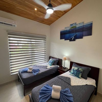 Beautiful bedroom #3 with two twin beds, AC and ceiling fan.