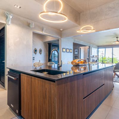 An elegant, open-concept kitchen, blending sleek surfaces with high-end finishes.
