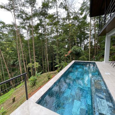 clear pool overlooking a stunning natural landscape, perfect for relaxation.
