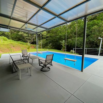 An elegant pool area with a sleek design, offering both luxury and comfort for outdoor living.