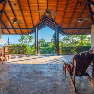 Extensive covered patio with pool access and ocean views