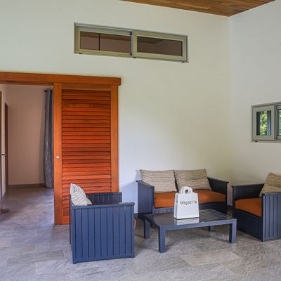 Outdoor covered sitting space next to the swimming pool