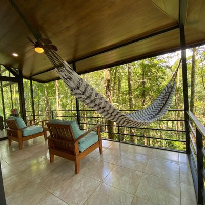 terrace offers panoramic views of lush greenery.