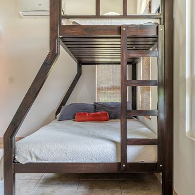 spacious room with a cozy bunk bed, perfect for extra sleeping space.