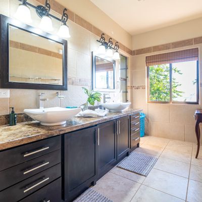 Master bedroom full bathroom with double sinks, indoor and outdoor shower