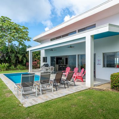 stunning poolside, with clear water and elegant lounging spaces for relaxation.