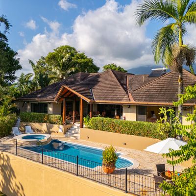 A stunning rear view of the house, with a tranquil pool and a serene outdoor space.