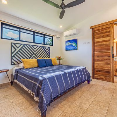 Main bedroom has king-size bed, A/C, ceiling fan and en-suite bathroom.