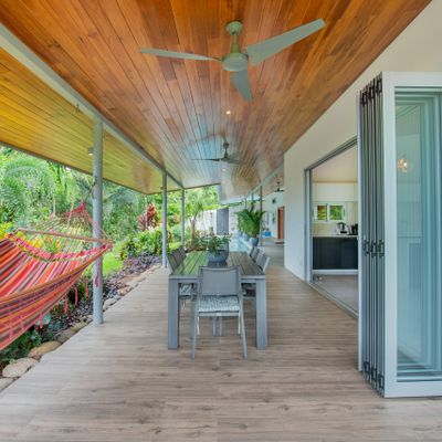 A large dining table with a beautiful view of the pool, perfect for outdoor meals.