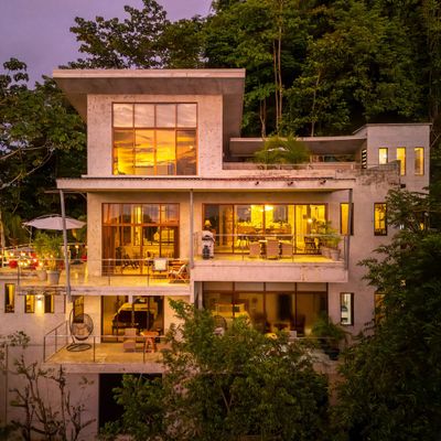 The soft, golden glow of the sunset dances across the windows, filling the house with warmth