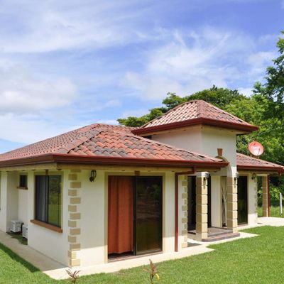 The front of the house features a beautiful garden and welcoming entrance