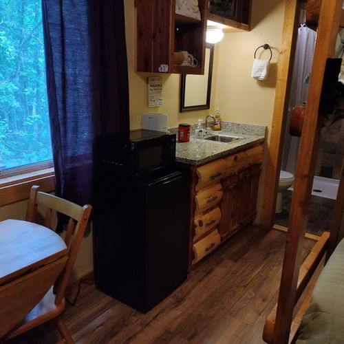 Main room:  includes two twin-on-twin bunk beds, a small dining table, chairs, and a kitchenette / sink.