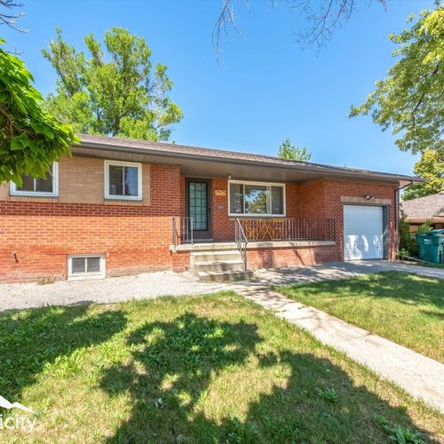 - welcoming red brick exterior with covered porch and steps up to the front door
- large picture window brings in natural light and neighborhood charm
- driveway and attached garage provide easy parking and storage space