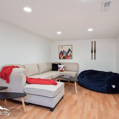 - relax in this cozy basement hangout with a plush sectional and giant bean bag
- bright art and red accents add personality to this inviting space
- whether reading or chatting, it’s the perfect corner for downtime fun