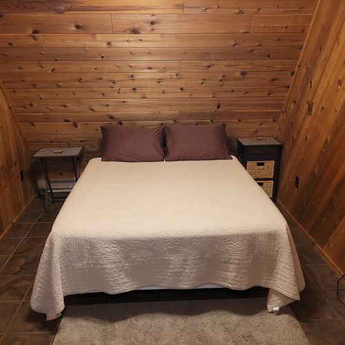 Bedroom #1 (main floor):  features a queen-size bed, private en suite bathroom, desk, dresser, mini-fridge, microwave, portable a/c unit, and its own private entrance.