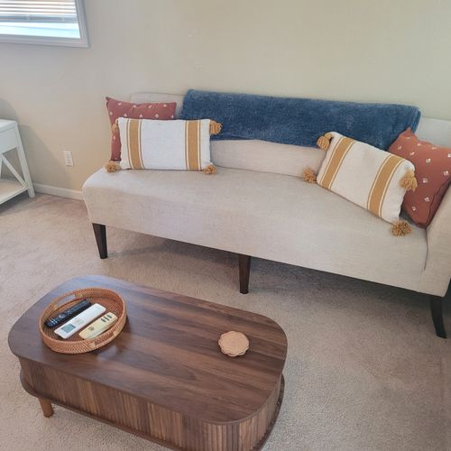 Bedroom #1:  a comfy couch and cute coffee table for relaxing that is next to the balcony access