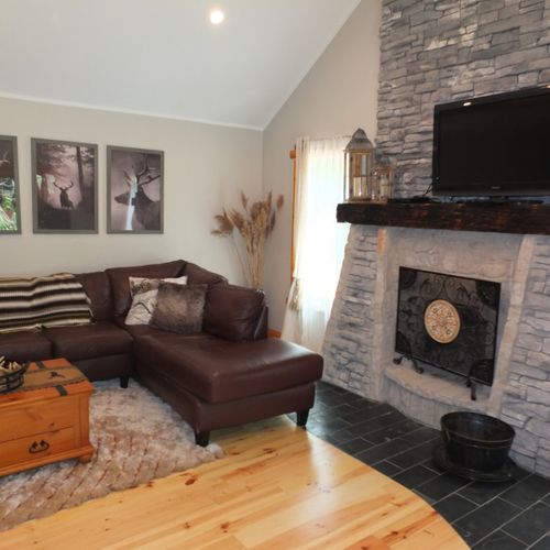 Overall:  an overview of the living room, which includes a nice wood fireplace that is available for guests to use.