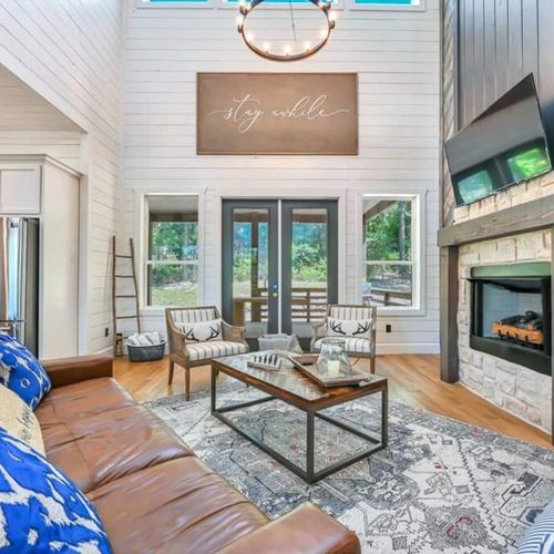 The living room is centered around the luxury fireplace and flat screen tv.