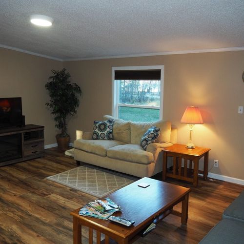 An overview of the living room. Note that green lake is visible through the window.