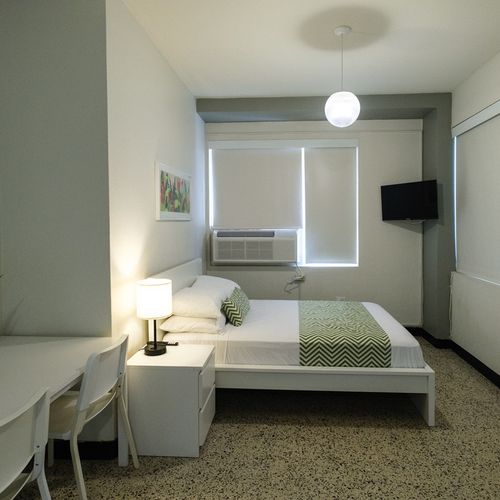 Our room is designed for your convenience, offering a comfortable bed and essential furnishings in a well-organized and inviting layout.