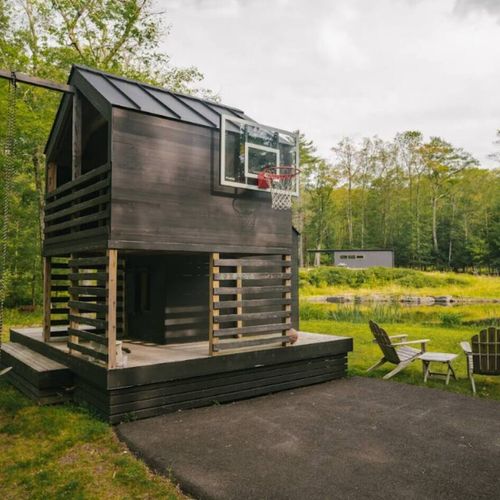 Playhouse with swing and basketball hoop, (guest house in background)