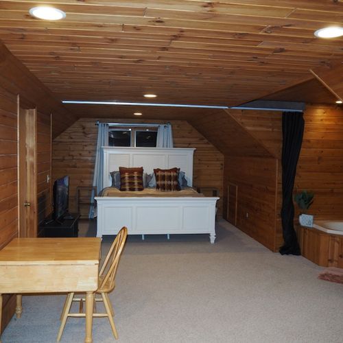 Bedroom #2 (second floor):  this is a huge upstairs bedroom with it's own television, desk, jetted tub, king-size bed, dresser, mirror, closet, and private en suite bathroom!