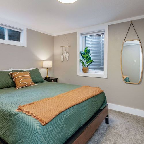 - get cozy in this earthy hideaway with rich green bedding and playful textures
- boho vibes meet boutique comfort with soft lighting, fun art, and beautiful touches
- whether napping or binge watching, this space is your chill out sanctuary