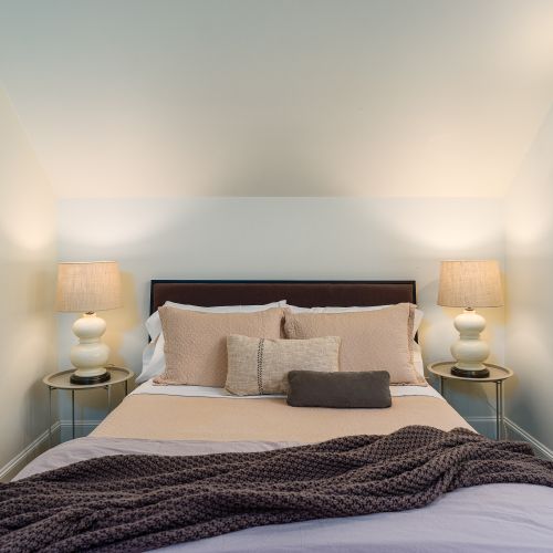 Soft lighting and neutral tones create a calm, relaxing retreat at the end of the day.